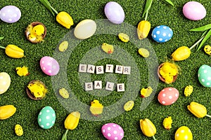 Easter sale banner with colorful eggs, tulips, chickens and sale text on a green grass background