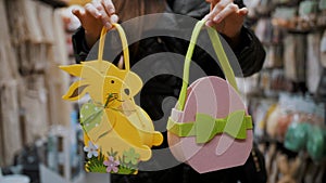 Easter sale. shopping of Easter decorations and gifts for home in the shop. decorative Easter felt bunny bags in female