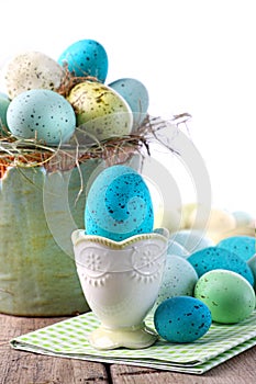 Easter scene with turquoise speckled egg in cup