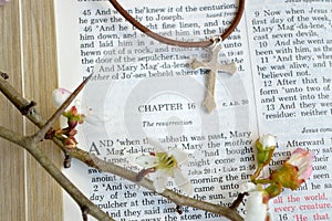 Easter scripture and cross with flowers