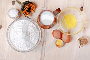 Easter set: eggs, heap of flour, glass of milk, sugar