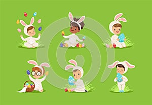 Easter with Smiling Children in Bunny Costume Playing with Decorated Eggs Sitting on Green Garden Lawn Vector Set
