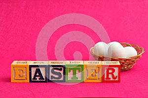 Easter spelled with colorful alphabet blocks and eggs
