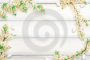 Easter spring background. Sakura flower, white happy easter egg on wooden spring background. Easter wallpaper. Spring