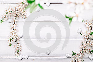 Easter spring background. Sakura flower, white happy easter egg on wooden spring background. Easter wallpaper. Spring