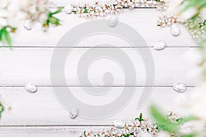 Easter spring background. Sakura flower, white happy easter egg on wooden spring background. Easter wallpaper. Spring