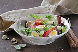 Easter Spring salad with quail eggs, tomatoes