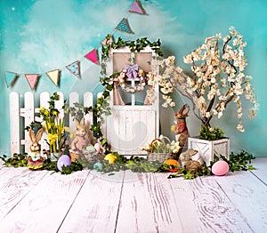 Easter spring sett up with colourful flowers pink flowers,bunny and easter eggs and vintage wood parquet