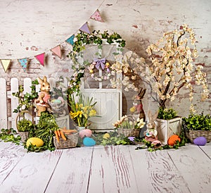 Easter spring sett up with colourful flowers pink and yellow flowers,bunny and easter eggs and vintage wood parquet