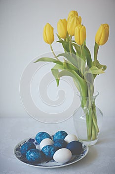 Easter still life with colored eggs and tulips