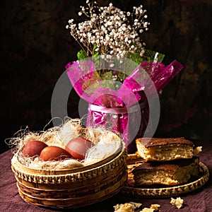 Easter still life. Eggs in a wicker basket. Christian holiday and food