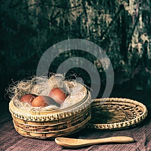 Easter still life. Eggs in a wicker basket. Christian holiday and food