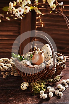 Easter still life with wicker basket filled with eggs in rustic style