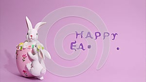 Easter stop motion animation. Beautiful Easter bunnies are moving in the frame, a plasticine inscription Happy Easter