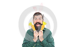 Easter surprises. cheerful guy holding carrots. spring holiday greeting. eastertide. surprised man