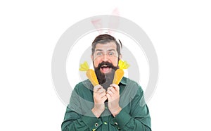 Easter surprises. cheerful guy holding carrots. spring holiday greeting. eastertide. surprised man photo