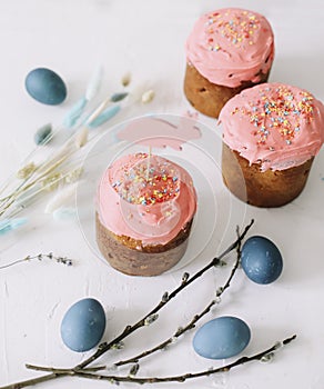 Easter table with Easter cakes, painted eggs and tree branches. Kulich decorated with icing.  Happy Easter concept