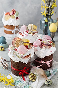 Easter table decoration with chocolate easter cake with colorful eggs and flowers