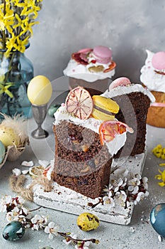 Easter table decoration with chocolate easter cake with colorful eggs and flowers