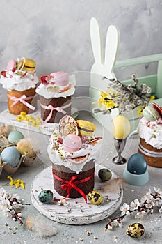 Easter table decoration with chocolate easter cake with colorful eggs and flowers