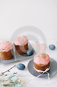 Easter table with Easter cakes, painted eggs and tree branches. Kulich decorated with icing.  Happy Easter concept