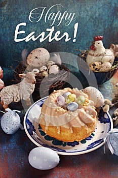 Easter table with homemade ring cake and decors on grunge background with greeting text photo