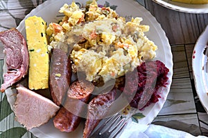 Easter table with salad, eggs, ham, sausage, beetroot and horseradish