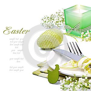 Easter table setting with candle and flowers