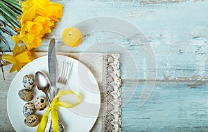 Easter table setting with daffodil and cutlery. Holidays background