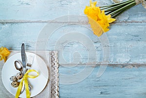 Easter table setting with daffodil and cutlery. Holidays background