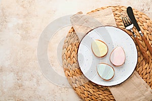 Easter table setting. Easter dinner with multicolored easter eggs. Elegance pastel and beige tablescapes. View from above.