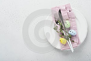 Easter table setting. Easter dinner with multicolored easter eggs. Elegance pastel and pink tablescapes. View from above.