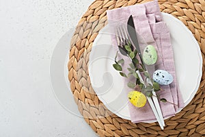 Easter table setting. Easter dinner with multicolored easter eggs. Elegance pastel and pink tablescapes. View from above.