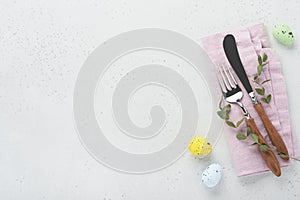 Easter table setting. Easter dinner with multicolored easter eggs. Elegance pastel and pink tablescapes. View from above.