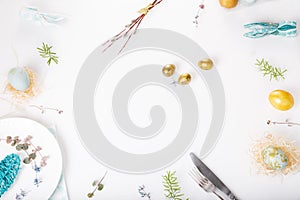 Easter table setting with gold and blue eggs and cutlery. Holidays background