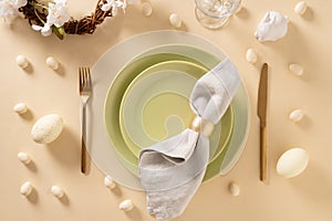 Easter table setting with green plate, cookies, eggs and bunny