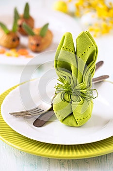 Easter table setting with a napkin folded as a bunny