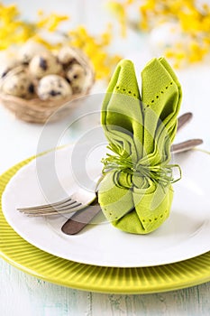 Easter table setting with a napkin folded as a bunny