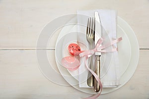 Easter table setting on white wooden background. Top view, copy space