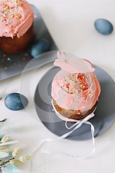 Easter table with Easter cakes, painted eggs and tree branches. Kulich decorated with icing.  Happy Easter concept