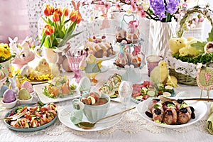 Easter table with traditional white borscht, sausage, deviled eggs, salads and pastries