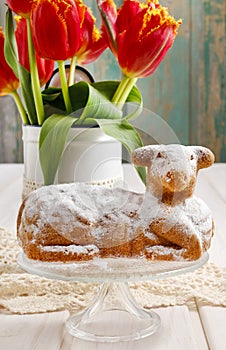 Easter traditional lamb cake and bouquet of red tulips