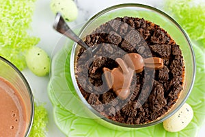 Easter treat idea chocolate mousse dessert with chocolate cookie crumbs and chocolate bunny candy