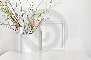 Easter. Vase with birch tree branches with Easter eggs and frame