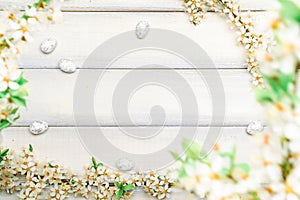Easter white background. Spring flower border, white happy easter egg on wooden spring background. Easter card. Flat lay