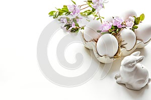 Easter. White bunny and eggs with flower. Preparing for coloration.