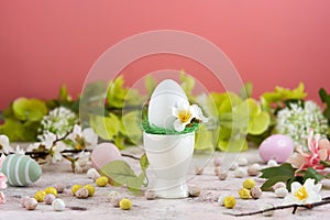 Easter white egs on colorful floral background. Easter greeting card. Copy space