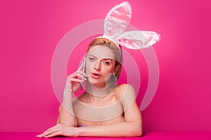 Easter woman with rabbit ears talking on phone.