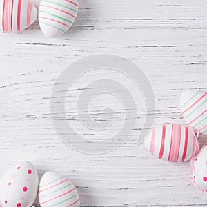 Easter wooden background with colored Easter eggs top view square shape copy space