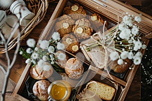 Easter Wooden Box with Treats with cookies and honey in rustic style decorated with spring flowers photo